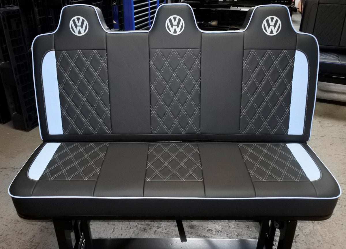 Rock and roll bed VW T4 T5 T6 3 seater in black upholstery with white inserts, stitching, piping and VW logos.