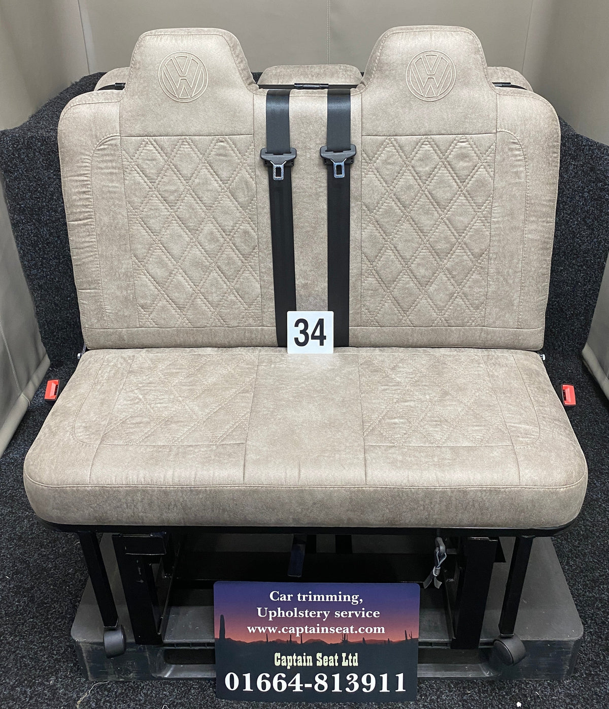 Rock & Roll Bed M1 Tested 3/4 Width, front view of beige faux suede seat with matching Bentley stitching and embroidered VW logos.