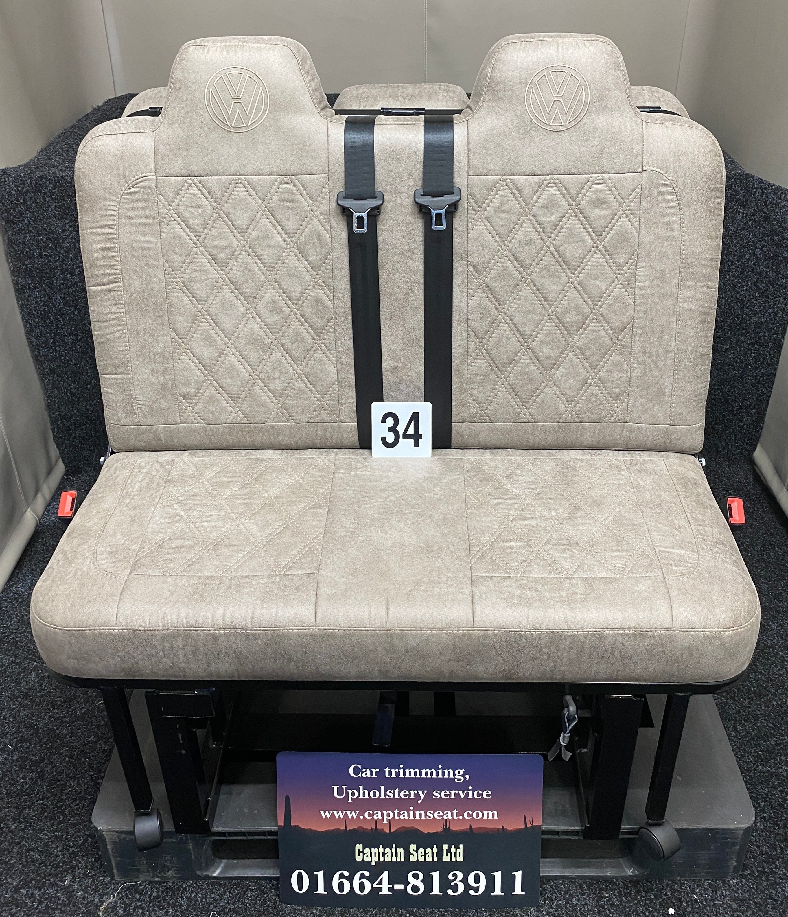 Rock & Roll Bed M1 Tested 3/4 Width, front view of beige faux suede seat with matching Bentley stitching and embroidered VW logos.