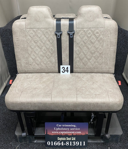 Rock & Roll Bed M1 Tested 3/4 Width, front view of beige faux suede seat with matching Bentley stitching and embroidered VW logos.