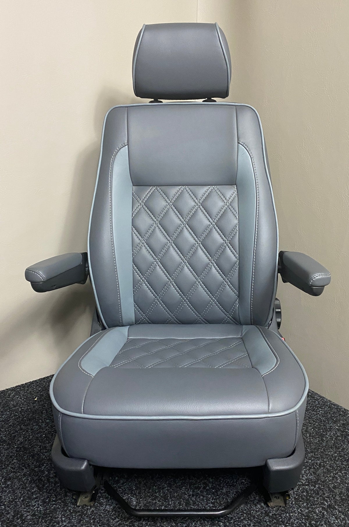 VW Factory Driver Seat T5 T6, front view of medium grey leatherette seat with light grey inserts, white Bentley cross stitching, and armrests.