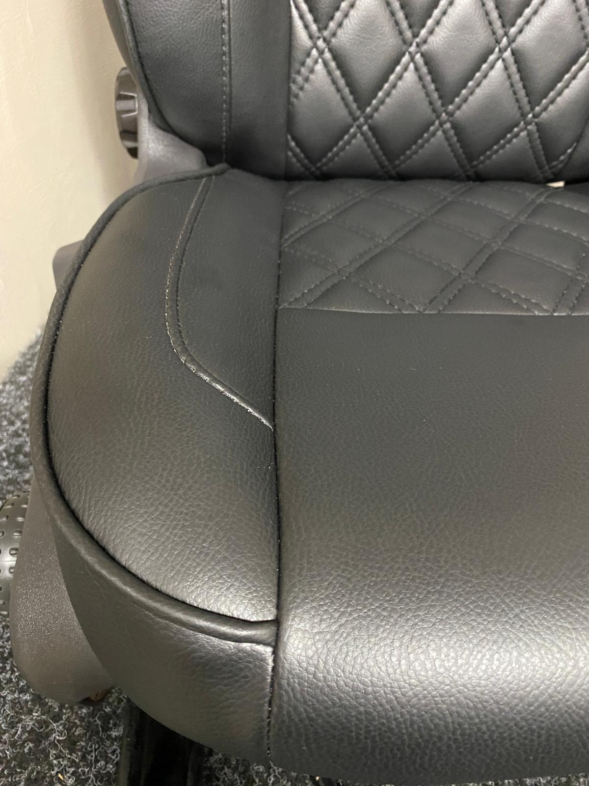 Close-up of Ford Transit Custom seat base, showcasing black leatherette upholstery with Bentley diamond stitch pattern.