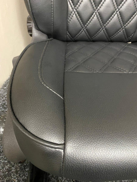 Close-up of Ford Transit Custom seat base, showcasing black leatherette upholstery with Bentley diamond stitch pattern.