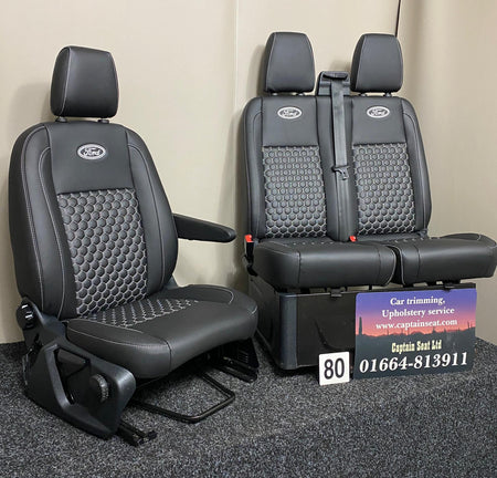 Ford Transit Custom front seats in black leatherette with honeycomb stitching and Ford logos, angled view