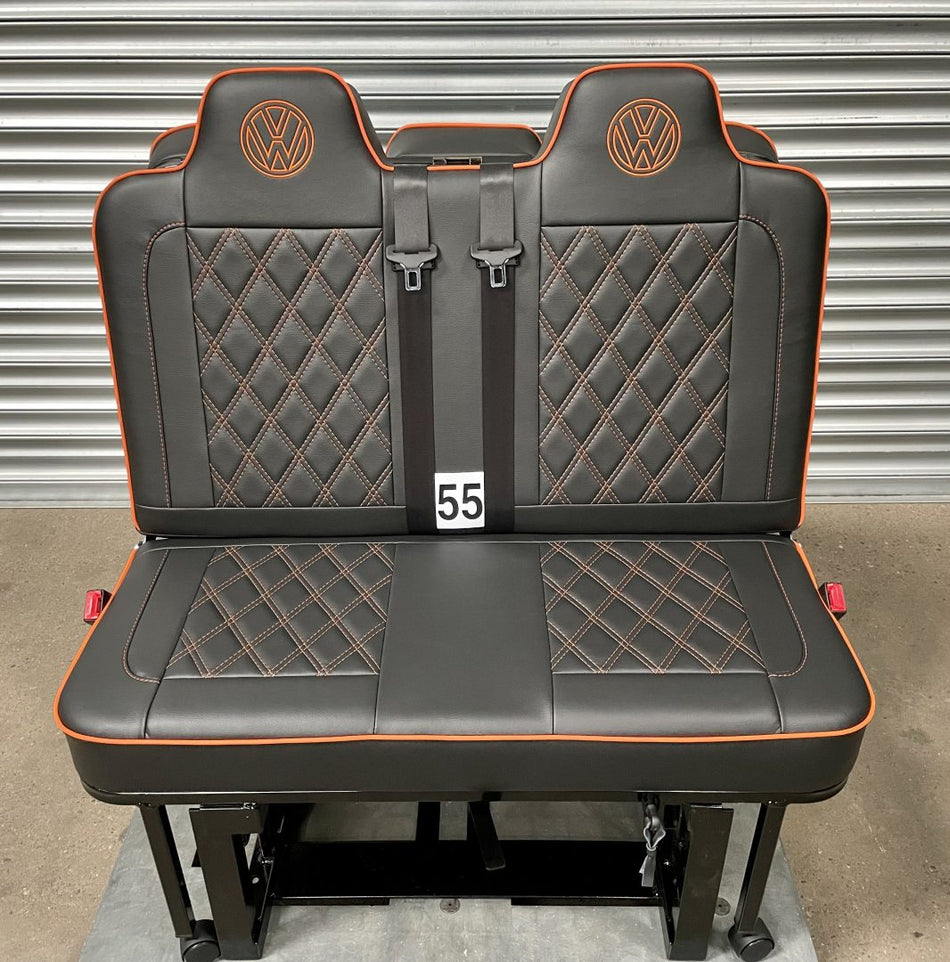 M1 tested 3/4 gas assisted rock and roll bed for VW T4 T5 T6 Crafter in black leatherette upholstery with Bentley cross stitch pattern, piping and VW logos.