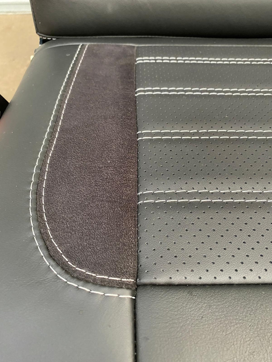 M1 tested 3/4 legless gas assisted rock and roll bed, close-up of the seat base, black perforated leather with light grey horizontal stitching.