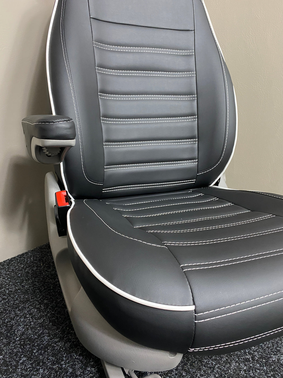 MK1 Replacement Swivel Captain Seat in black leatherette with white horizontal stitching, white leatherette piping, light grey plastic trim and armrest.
