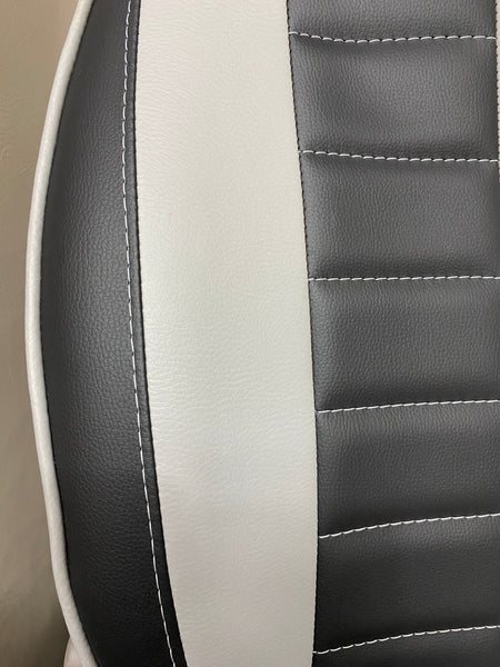 MK1 Replacement Swivel Captain Seat close-up, showing grey insert, horizontal wide stitching, and white piping on black leatherette.