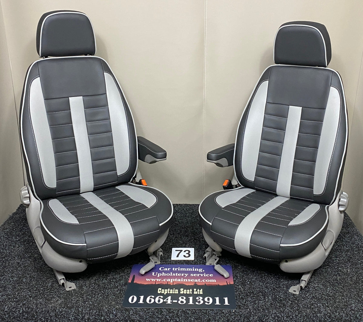 MK1 Replacement Swivel Captain Seats in black leatherette with wide horizontal grey stitching, grey inserts, light grey trim and armrests.
