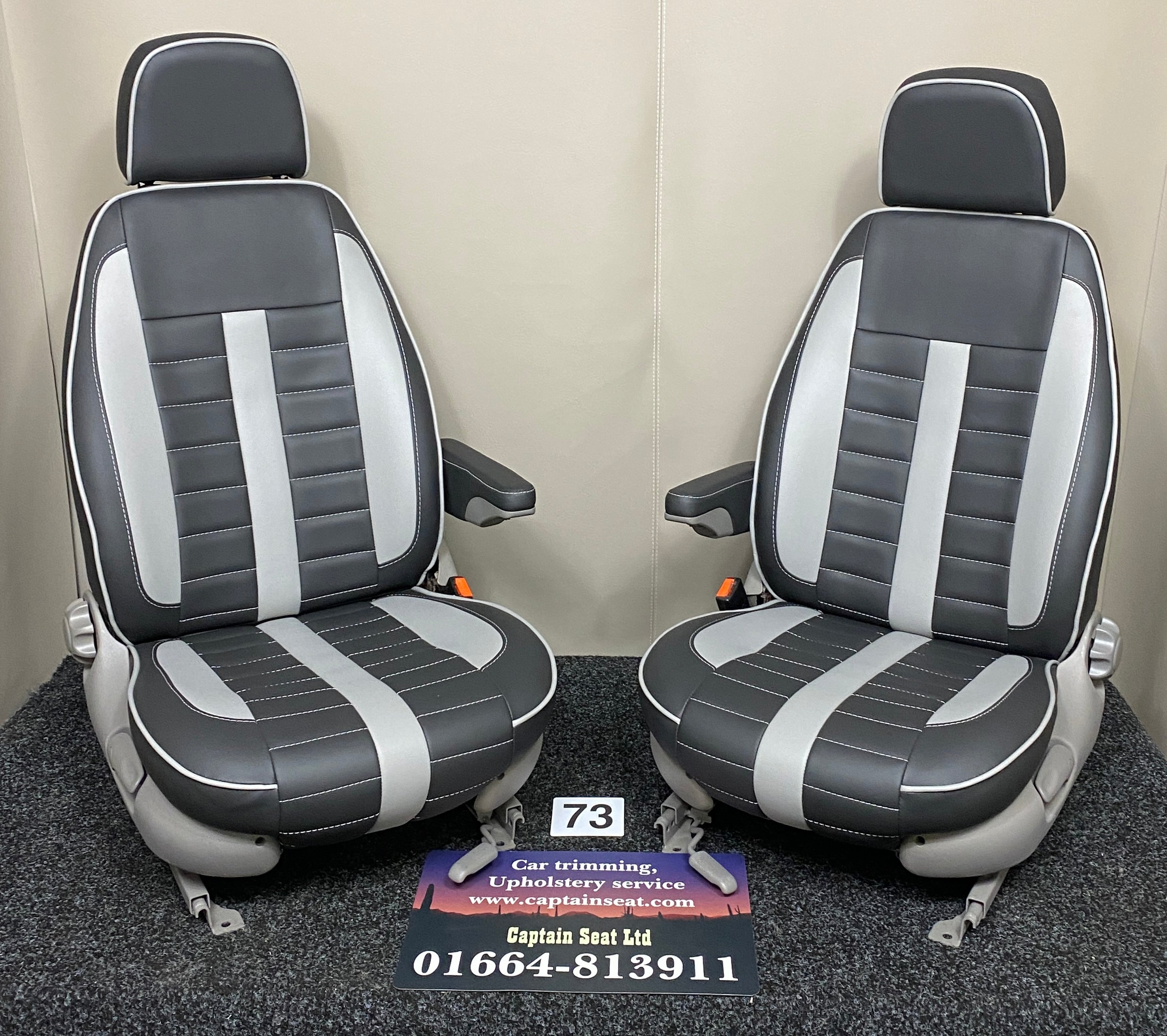 MK1 Replacement Swivel Captain Seats in black leatherette with wide horizontal grey stitching, grey inserts, light grey trim and armrests.
