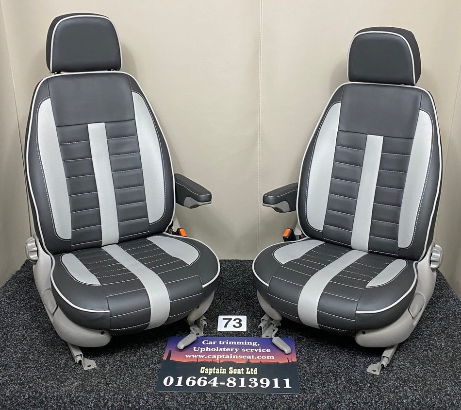 MK1 Replacement Swivel Captain Seats in black leatherette with wide horizontal grey stitching, grey inserts, light grey trim and armrests.