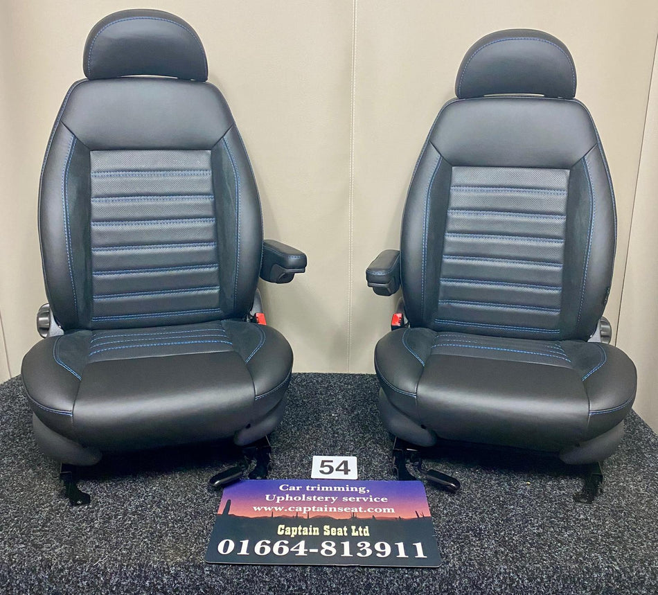 MK2 Replacement Swivel Captain Seats, a pair of swivel seats with black Nappa leather, perforated centre panel, black Alcantara inserts, and blue stitching.