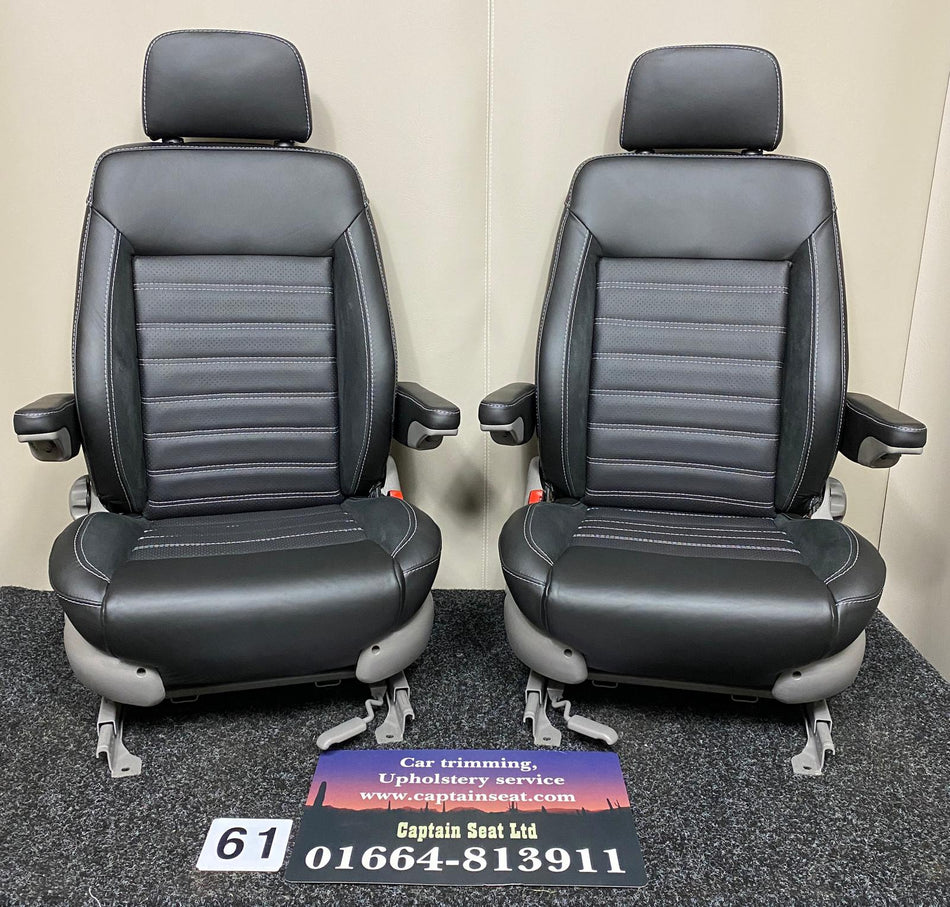 MK3 Replacement Swivel Captain Seats with black real leather, perforated center panels, Alcantara inserts, light grey stitching, and folded down armrests.