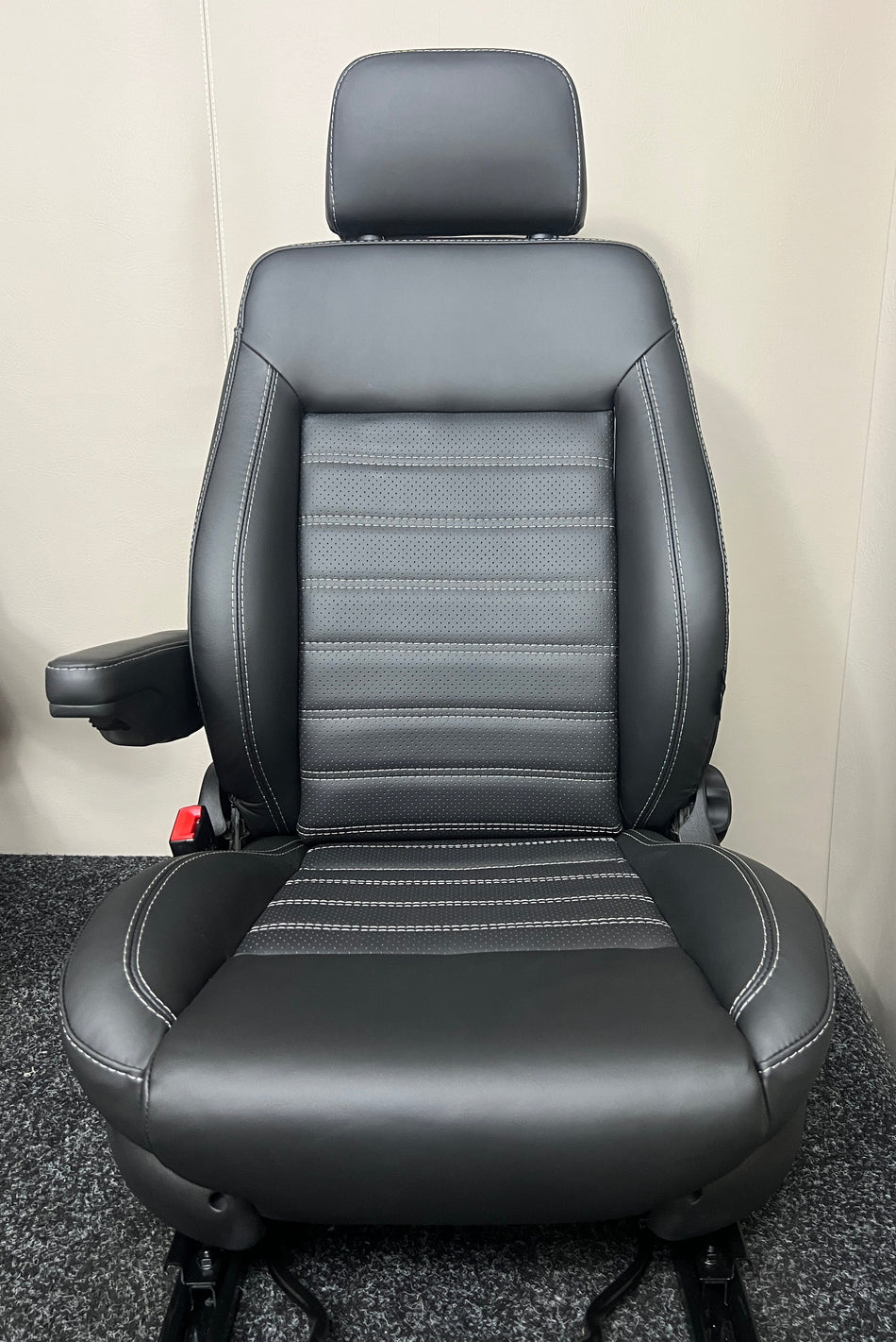 MK3 Replacement Swivel Captain Seat in black real leather with black perforated centre panel and mild grey horizontal wide stitching with single armrest and dark grey plastic trim.