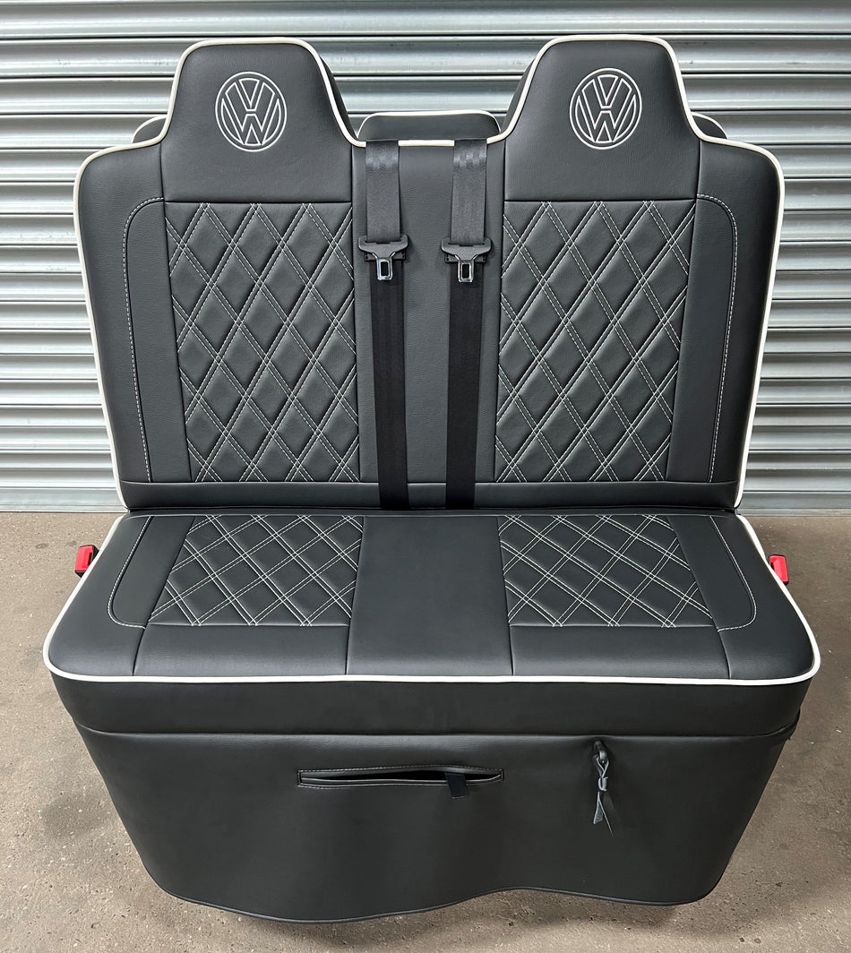 Non tested 3/4 gas assisted rock and roll bed in black leatherette upholstery with white stitching, piping and VW logos.