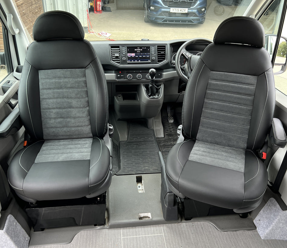 Pair of MK 2 Replacement Swivel Captain Seats in matt black leatherette with upgraded centre panels in dark grey faux suede with horizontal stitch pattern.
