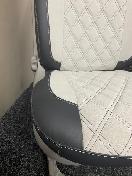 MK1 Replacement Captain Swivel Seat, close-up, showcasing the black leatherette edge panel and white microfibre centre panel with Bentley cross stitch pattern.