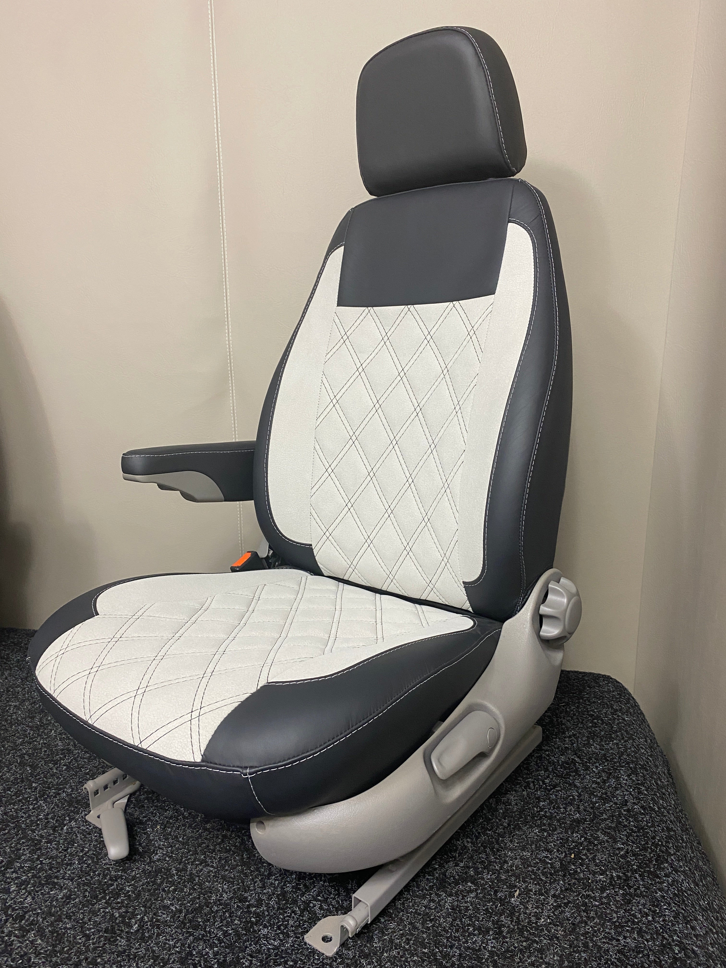 MK1 Replacement Captain Swivel Seat, shown from a front-side angle highlighting the detailed stitch pattern on white microfibre, and black Nappa leather.