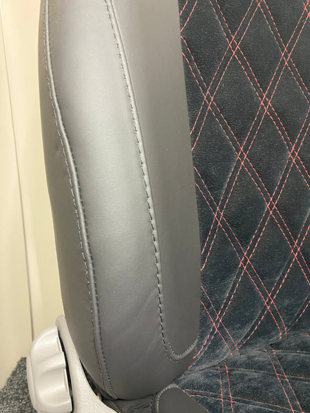 MK1 Replacement Captain Swivel Seat, close-up of black Nappa leather side panel and red stitched black microfibre seat base.