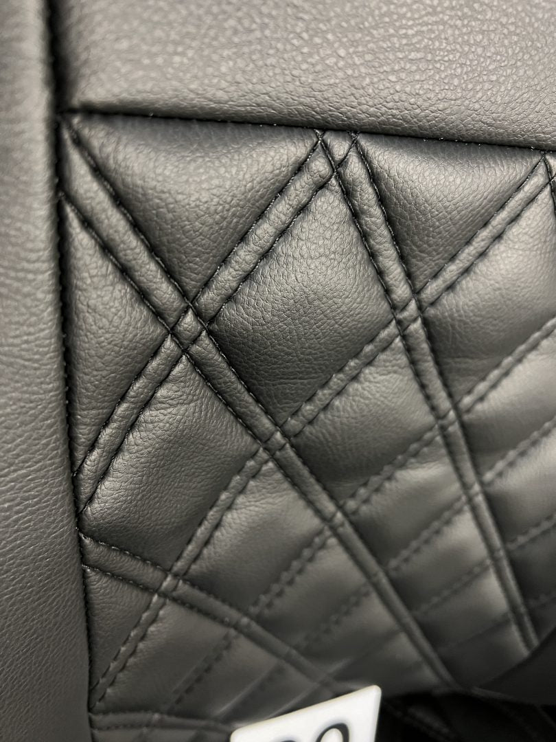 MK1 Replacement Swivel Captain Seat, close-up of the backrest in matt black leatherette upholstery with Bentley stitching.