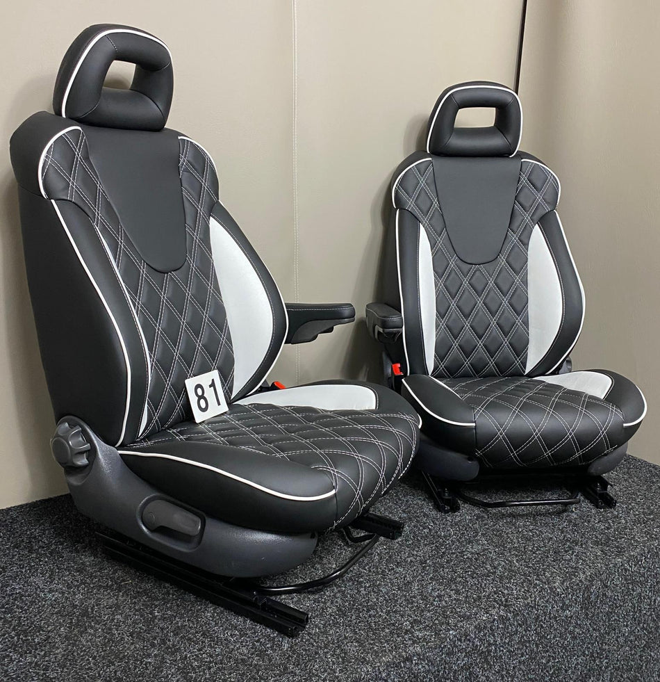 MK2 Replacement Captain Swivel Seats in black leatherette with white inserts and diamond stitching, angled view