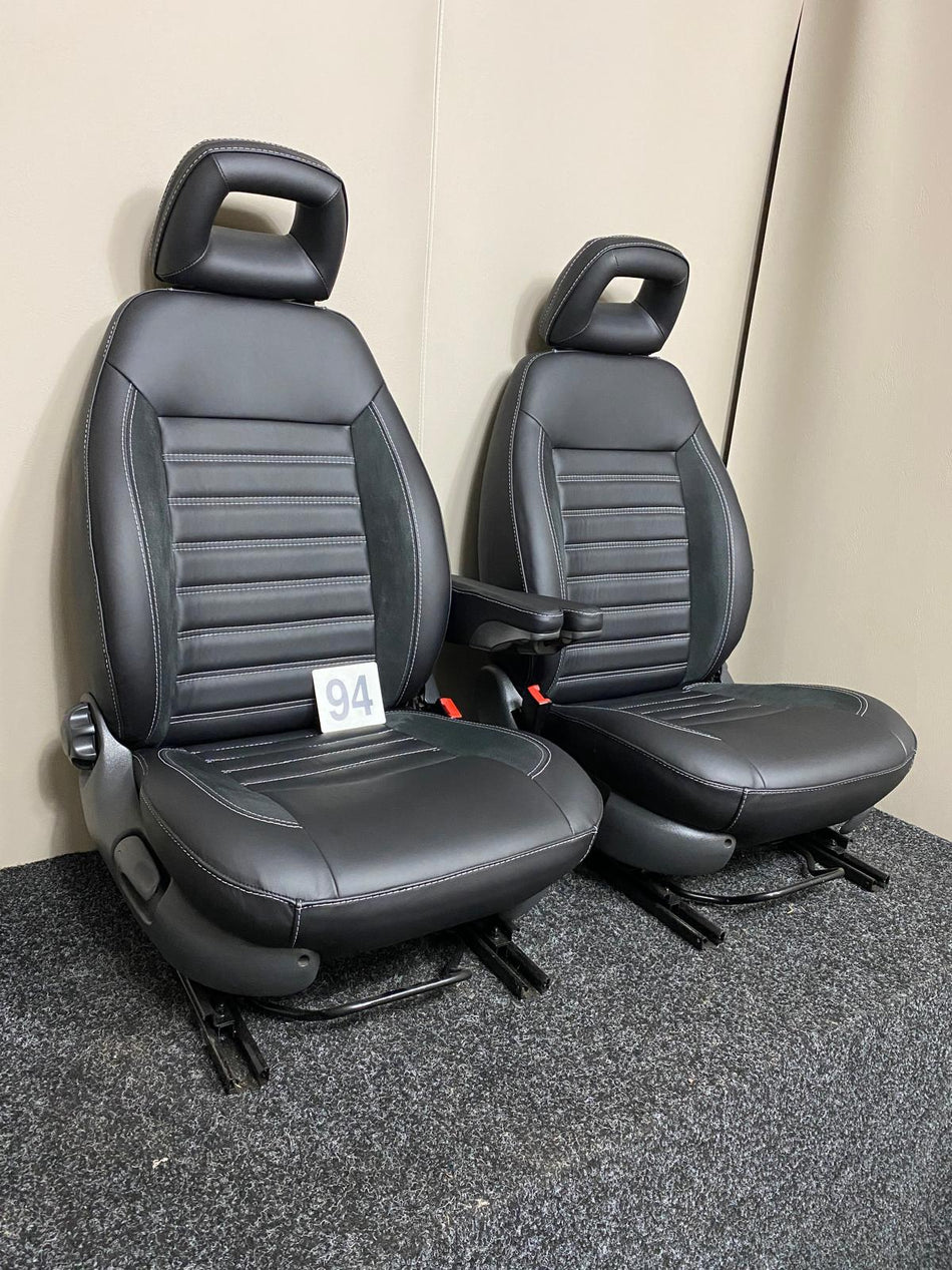 MK2 Replacement Captain Swivel Seats in black Nappa leather with horizontal stitching, angled view