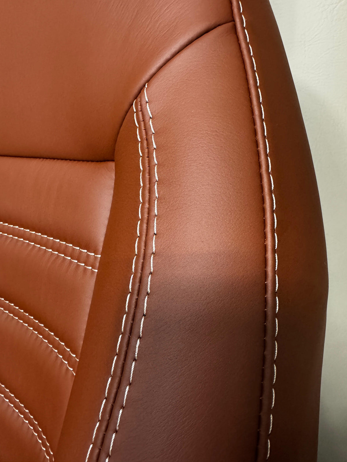 MK2 Replacement Captain Swivel Seat close-up, brown Nappa leather with white stitching