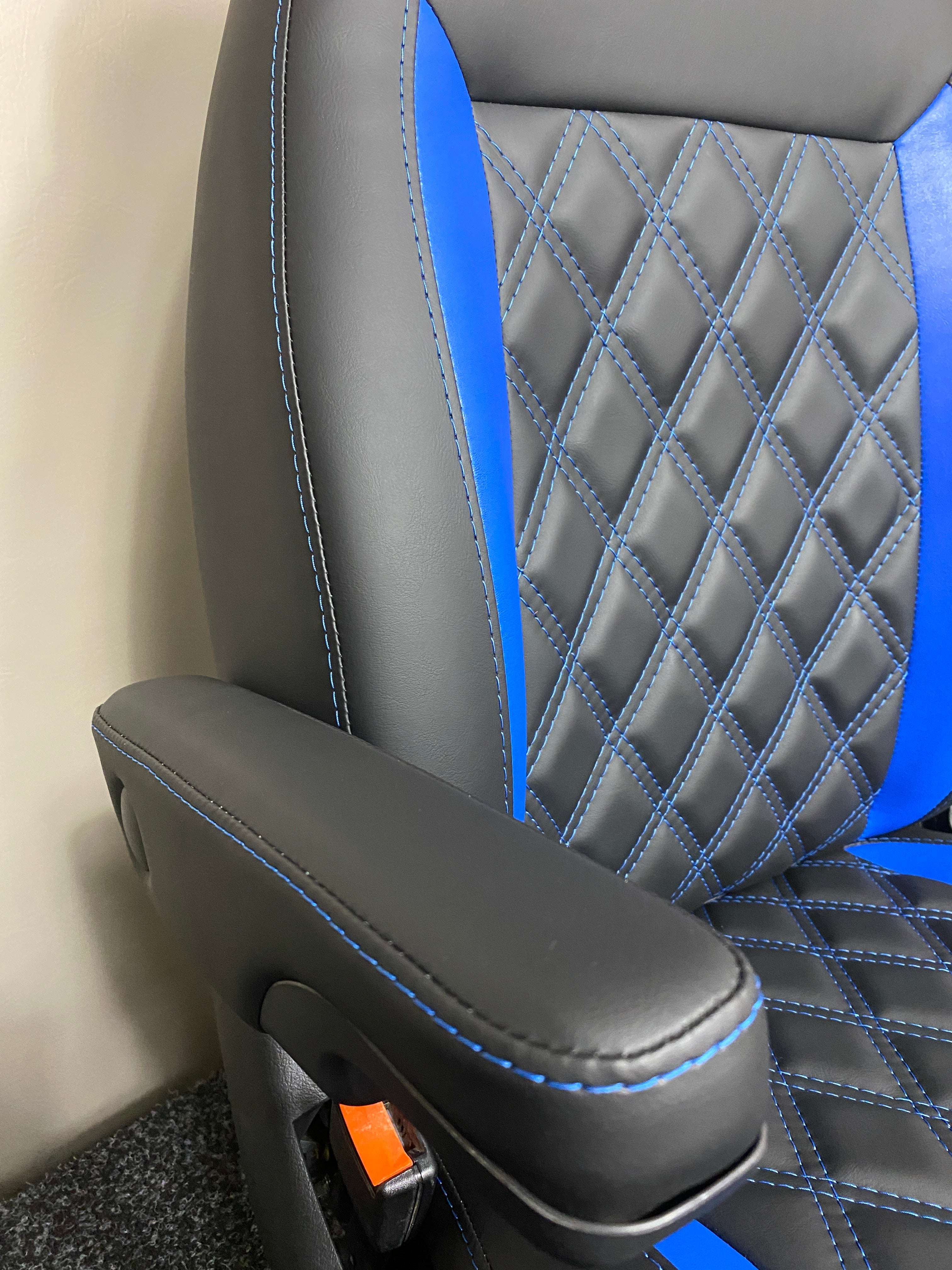 MK2 Replacement Swivel Captain Seat, close-up of the armrest, edge panel and the diamond stitched backrest.