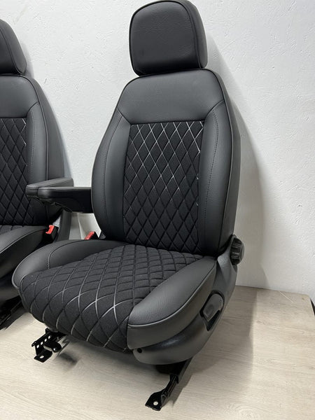 Pair of MK2 Swivel Replacement Captain Seats, angled view showing matt black leatherette, black faux centre panel, and one armrest per seat.