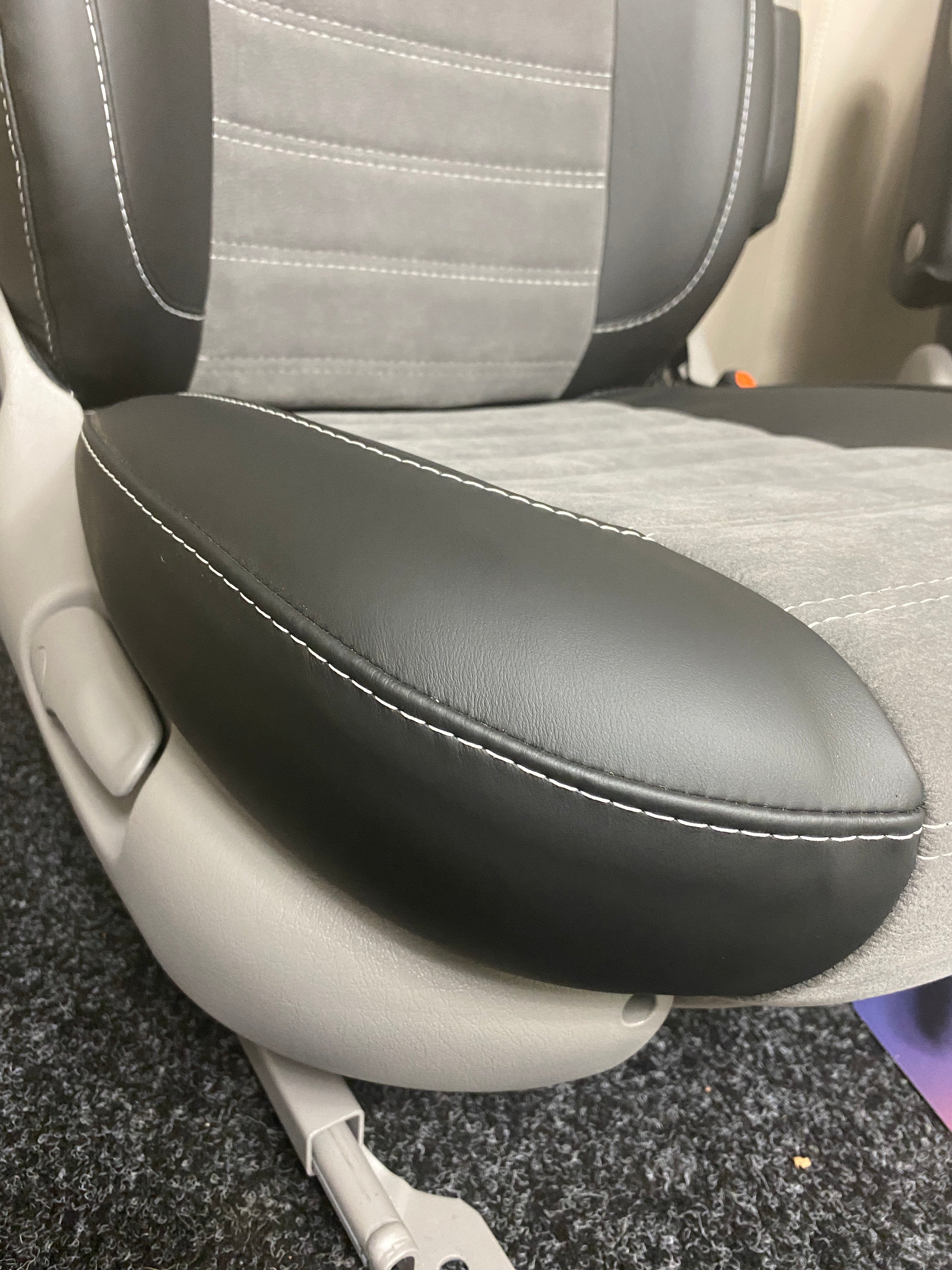 MK2 Swivel Replacement Captain Seat, close-up of the seat base with black leatherette side panel and light grey centre panel.