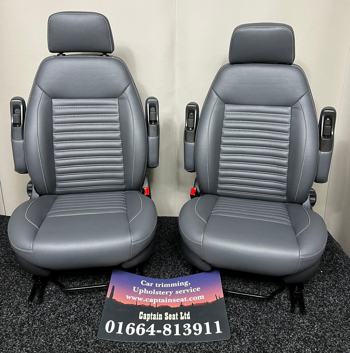Pair of MK2 Swivel Replacement Captain Seats in grey leatherette with wide horizontal stitching.
