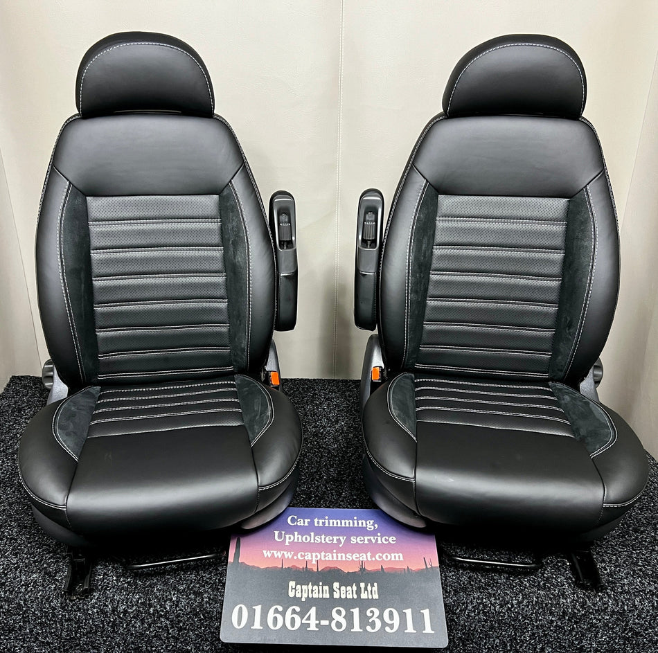 Pair of MK2 Swivel Replacement Captain Seats in black smooth real leather with black Alcantara inserts, perforated centre panel and grey horizontal stitching.