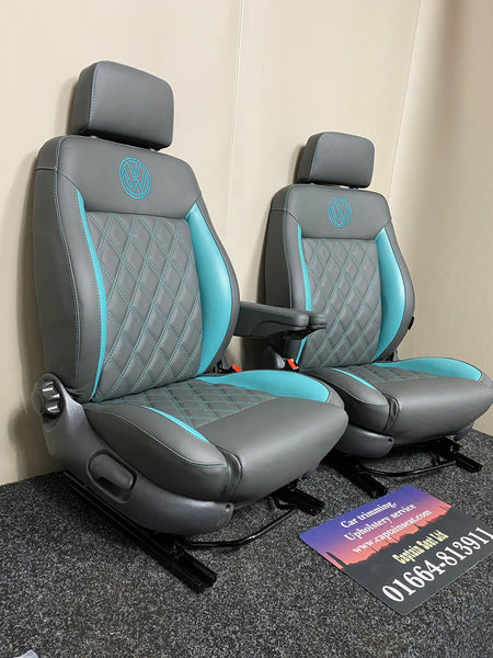 Pair of MK3 Replacement Captain Swivel Seats upholstered in grey real leather with teal cross-stitch, teal side inserts, and VW embroidered logos, shown from a side angle.