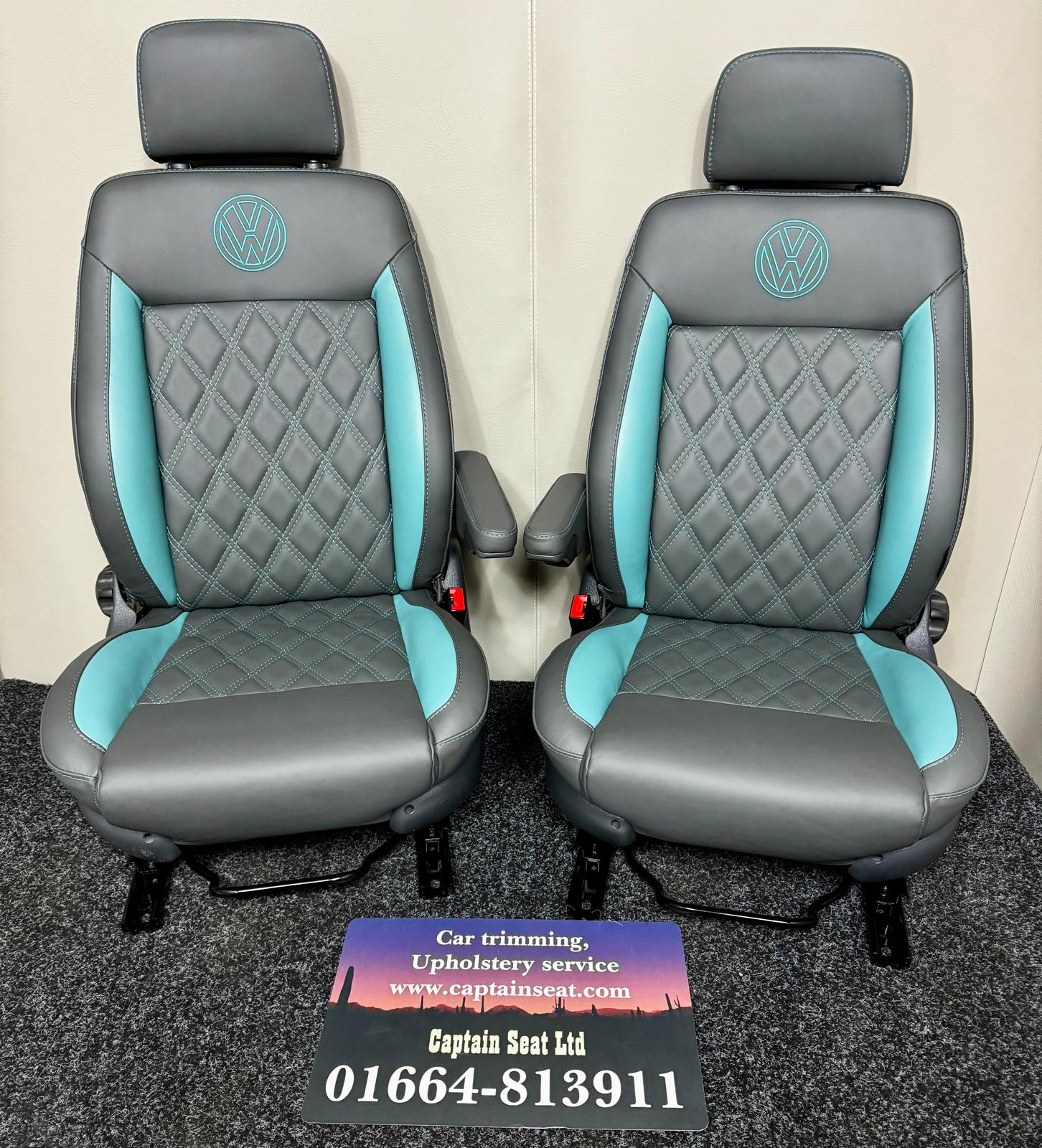 Pair of MK3 Replacement Captain Swivel Seats in grey real leather with teal inserts and horizontal teal stitch pattern. Features a VW logo embroidered in teal on the headrests, one armrest per seat.