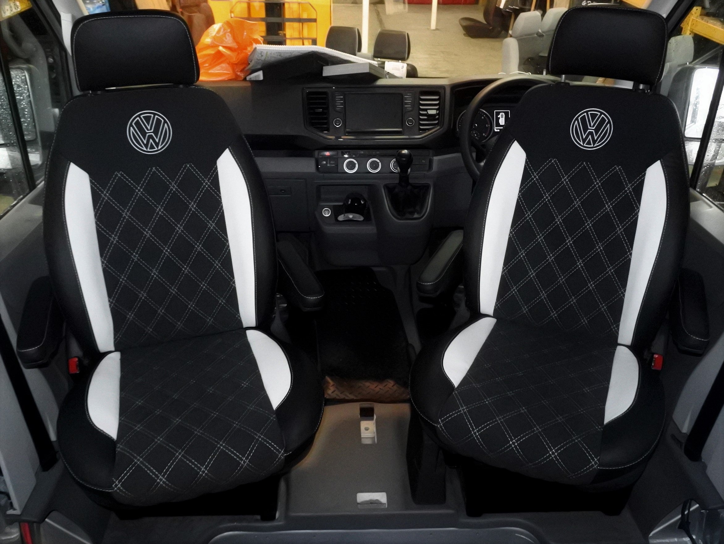 Pair of VW Crafter Replacement Swivel Captain Seats, in matt black leather upholstery with white Bentley stitching, inserts and VW logos.