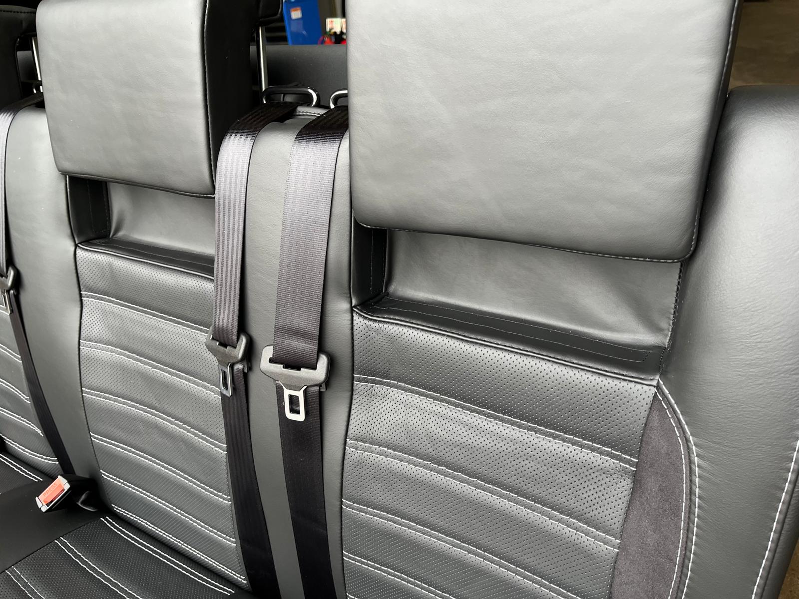 RIB Altair 130 with Isofix close-up of black Nappa leather seats, perforated centre panel, black Alcantara inserts, light grey stitching, and integrated seatbelts.
