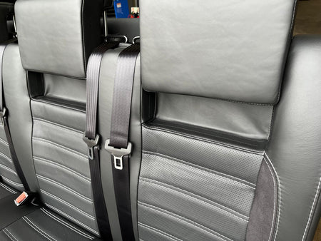 RIB Altair 130 with Isofix close-up of black Nappa leather seats, perforated centre panel, black Alcantara inserts, light grey stitching, and integrated seatbelts.