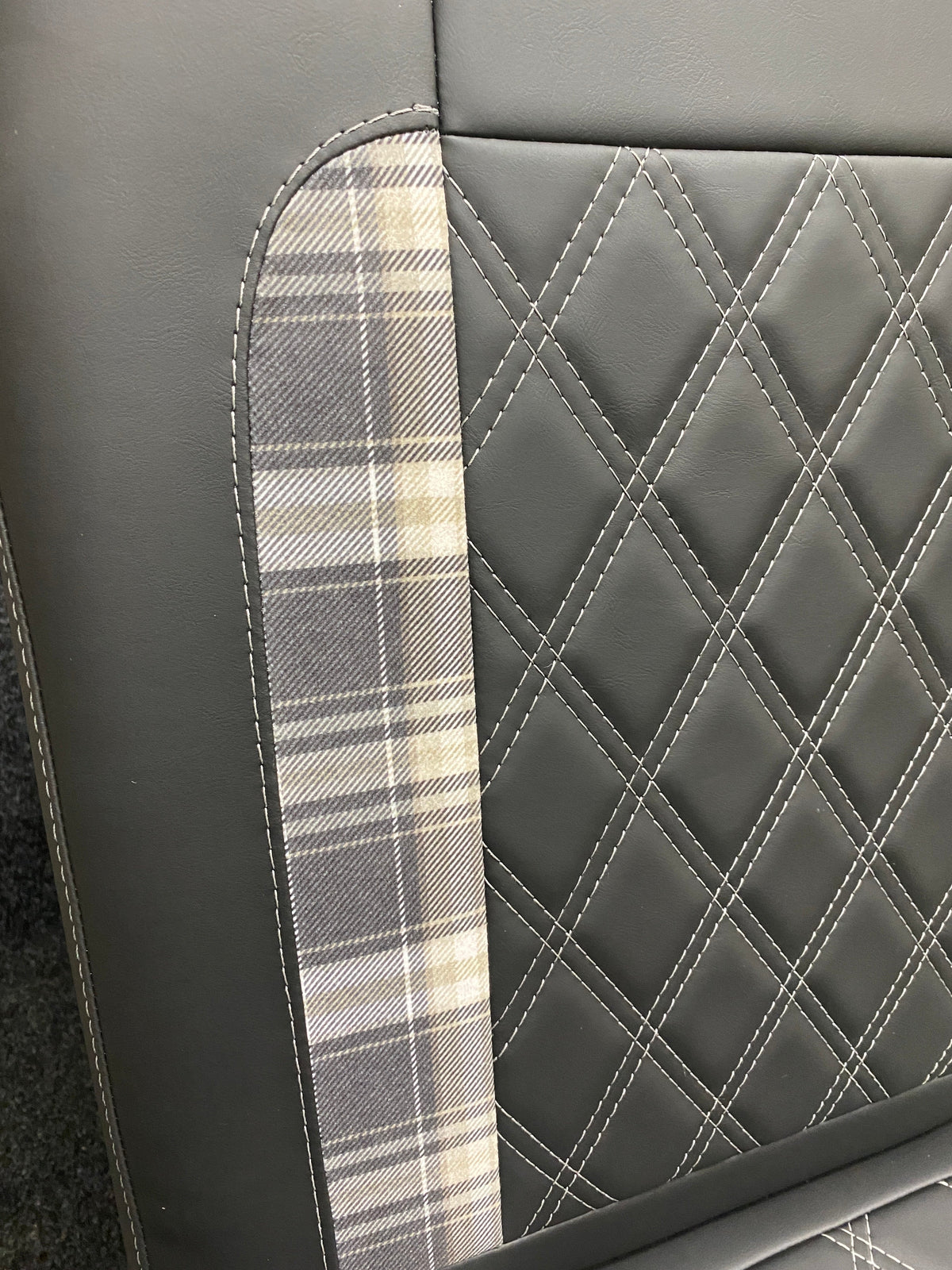 Rock and Roll Bed 3/4 Size M1 Legged Gas Assisted, Close-up of the backrest showing tartan insert and white Bentley cross stitching on black leatherette.