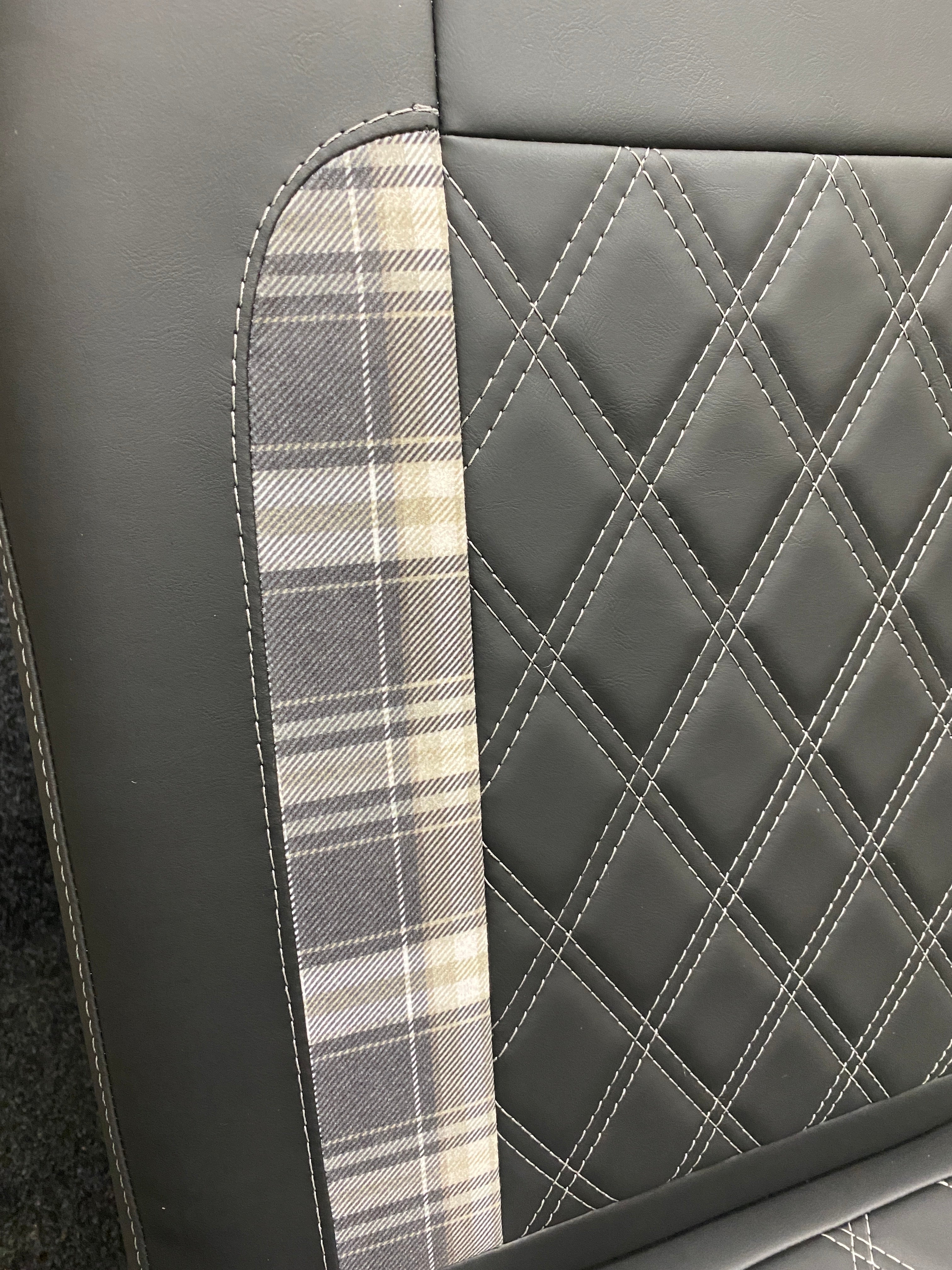 Rock and Roll Bed 3/4 Size M1 Legged Gas Assisted, Close-up of the backrest showing tartan insert and white Bentley cross stitching on black leatherette.