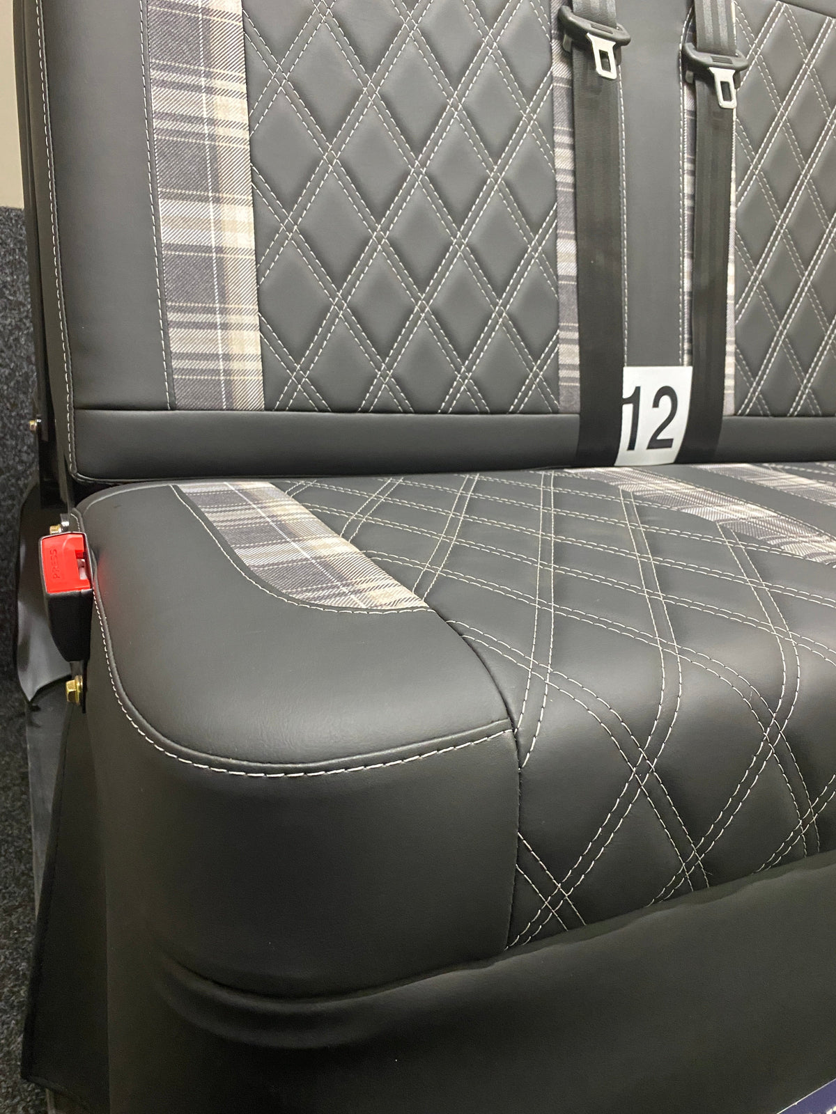 Rock and Roll Bed 3/4 Size M1 Legged Gas Assisted, close-up of seat base and backrest, in black leatherette with tartan inserts and white Bentley cross stitching.