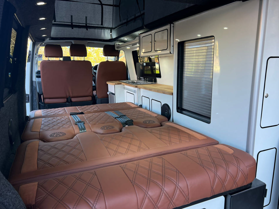 Rock and Roll Bed Custom 120cm in brown leatherette with tan inserts, shown in the fully folded-flat bed position.