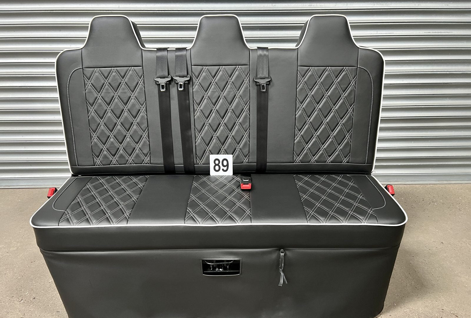 Rock and roll bed full width 3 seater M1 tested gas assisted in black leatherette with white Bentley stitching and piping.