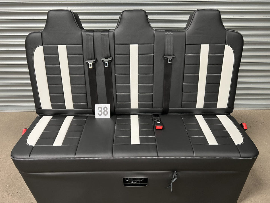 Rock and roll bed full width M1 tested gas assisted legged in black leatherette with white stitching, insterts and integrated seatbelts.