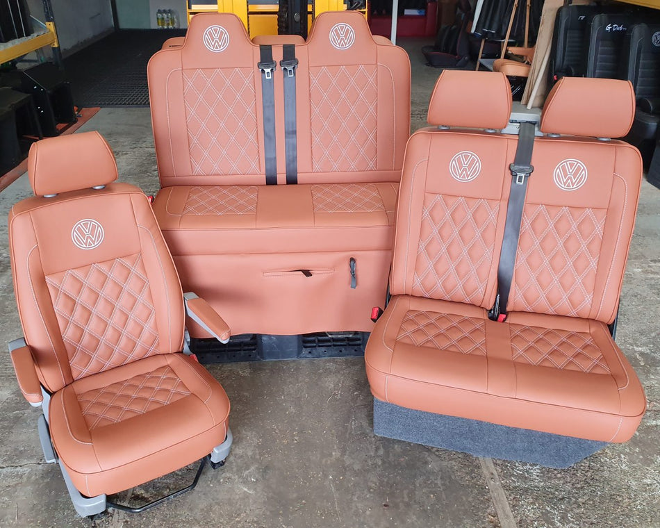 Rock and Roll bed M1 tested and matching front seats for VW T5 T6 in brown upholstery with white stitching and VW logos.