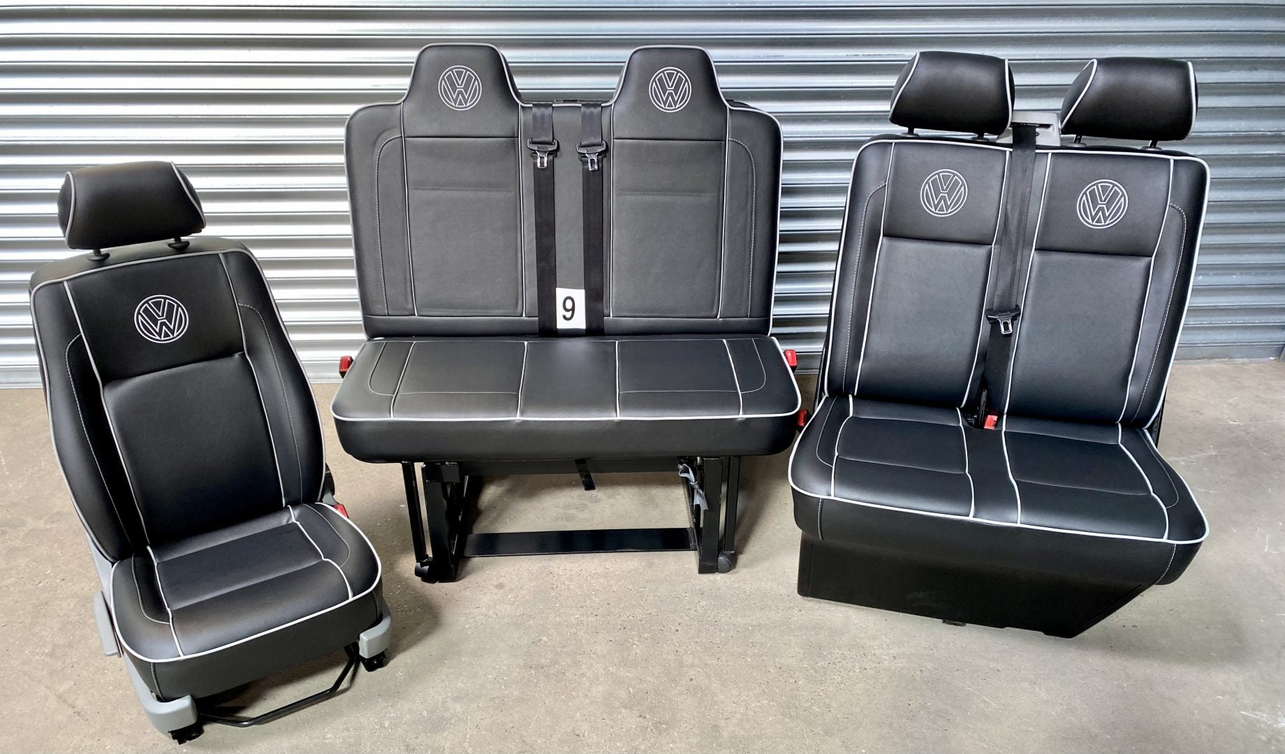 Rock and roll bed M1 tested gas assisted + front seats VW T5 T6 in black leatherette with grey double piping and VW logos.