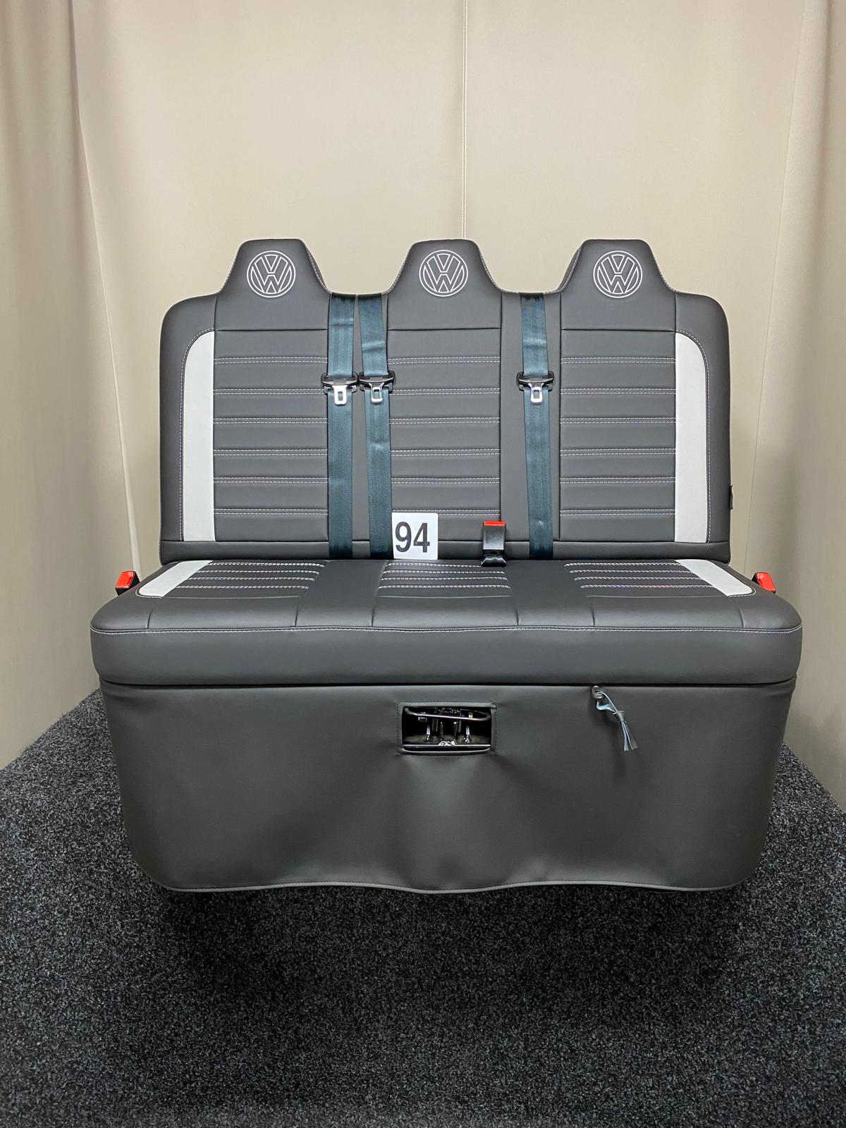 Rock and roll bed Three Seater-gas assisted leisure-120 cm in black leatherette with light grey inserts, light grey Bentley cross stitching, and VW logos on the headrests.