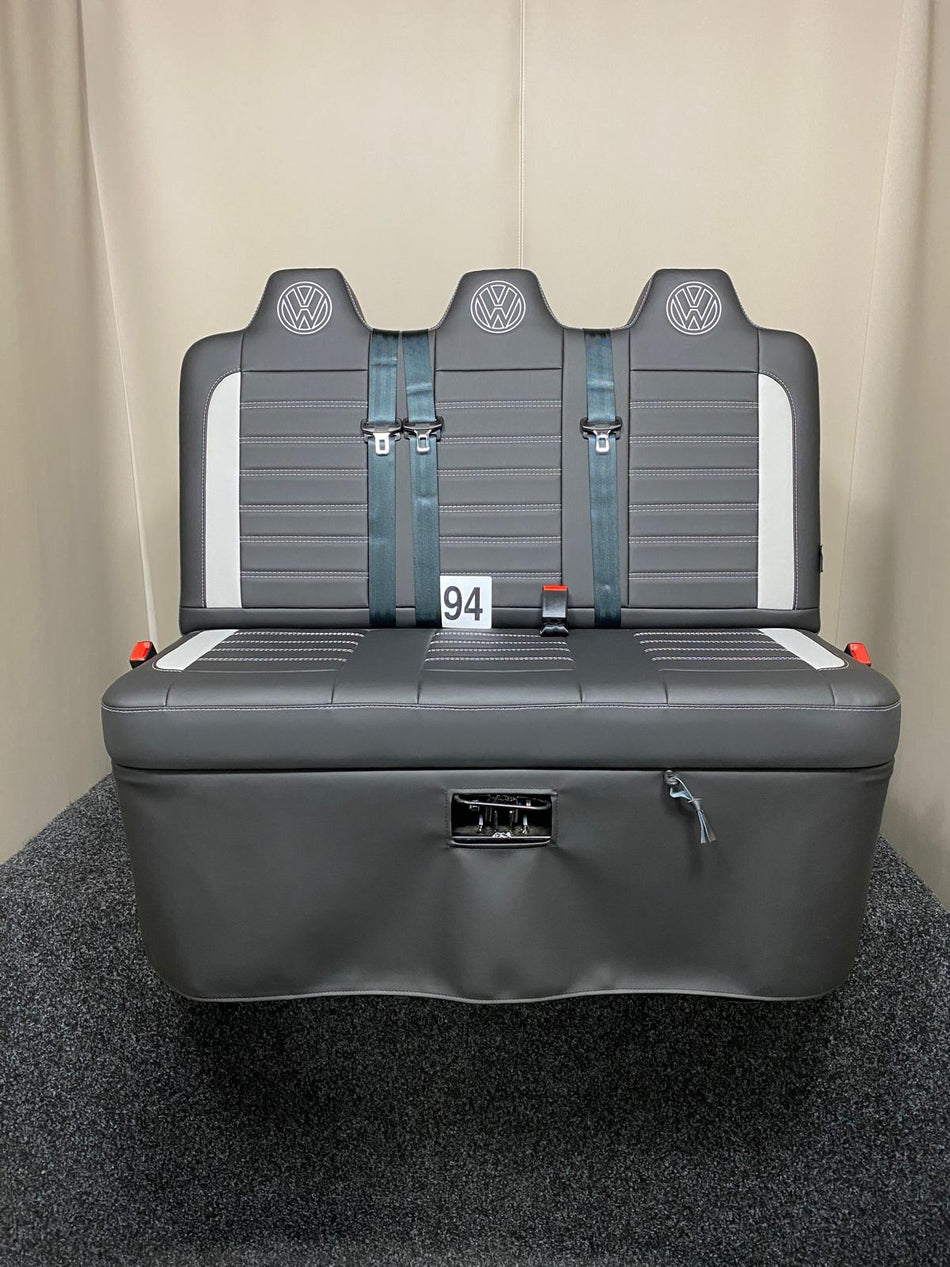 Rock and roll bed Three Seater-gas assisted leisure-120 cm in black leatherette with light grey inserts, light grey Bentley cross stitching, and VW logos on the headrests.