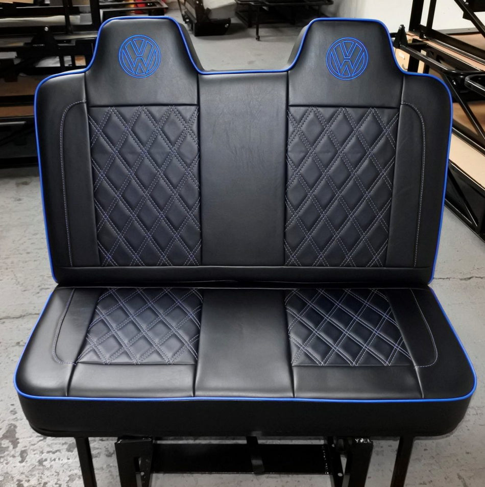 Rock and roll bed VW T4 T5 T6 M1 legged in black leatherette with blue piping, VW logos and white Bentley stitching.