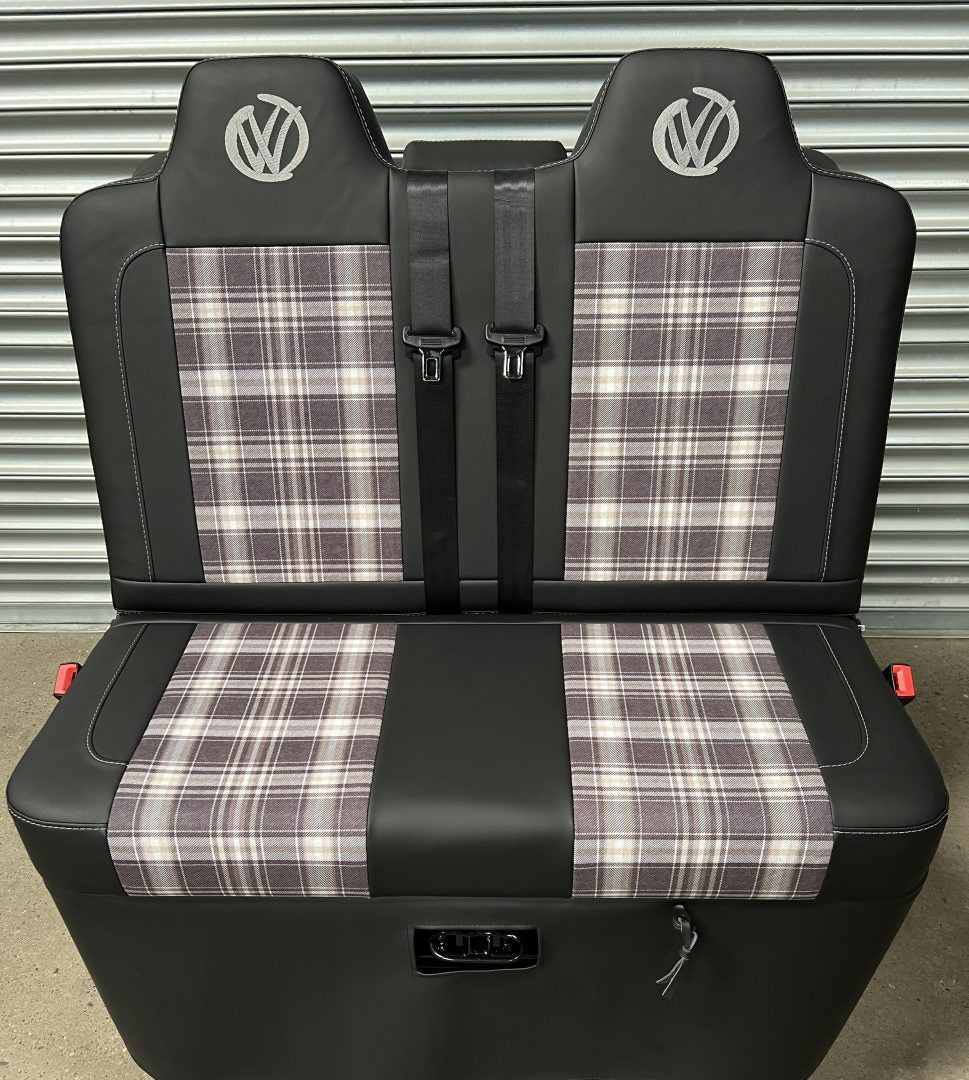 Rock and roll bed VW T5 T6 front view of black leatherette upholstery, with upgraded tartan fabric centre panels and grey graffiti VW logos.
