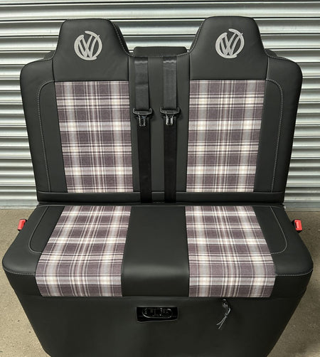 Rock and roll bed VW T5 T6 front view of black leatherette upholstery, with upgraded tartan fabric centre panels and grey graffiti VW logos.